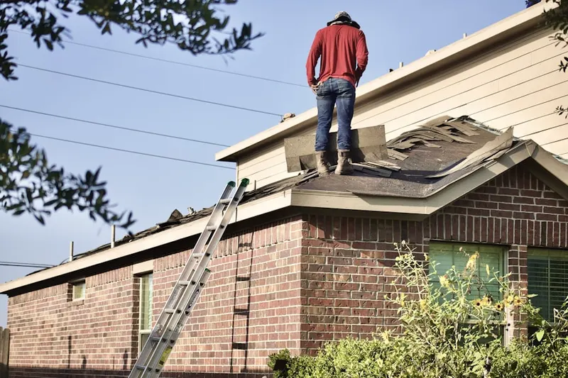 Professional roofer working on a residential roof in Dixon